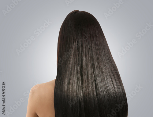 Young woman with beautiful healthy hair on white background