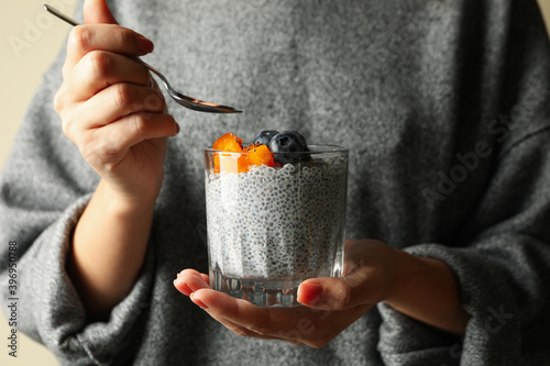 Tableau sur toile Woman in sweater eat delicious chia pudding
