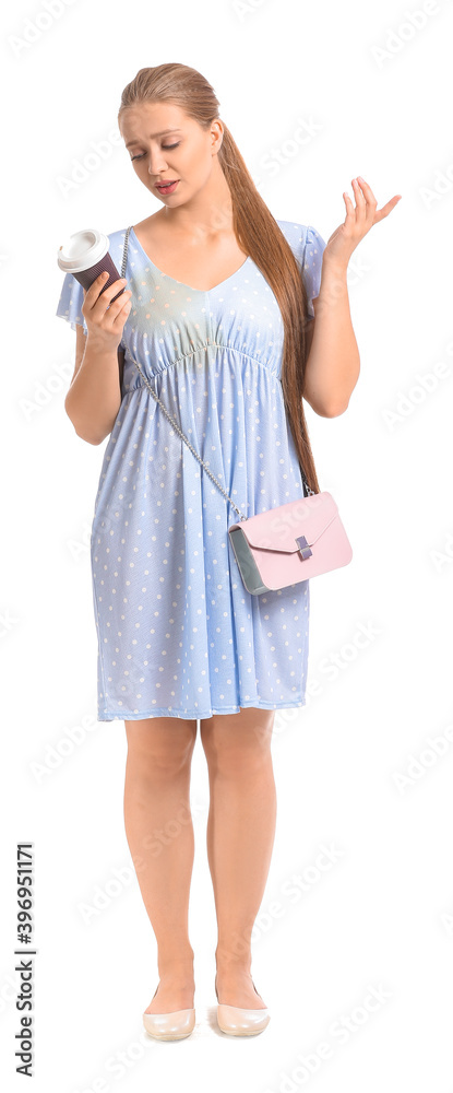 Young woman with coffee stains on her dress  on white background