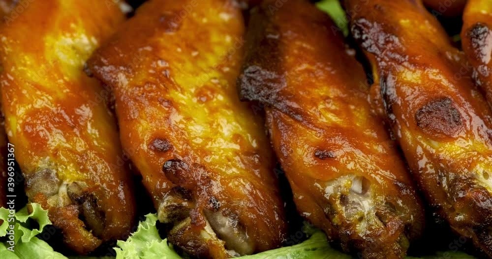Truck shot of chicken wing stick grilled on green lettuce ready for eating, 4K DCI, ProRes HQ Truck shot of chicken wing stick grilled on green lettuce ready for eating, 4K DCI, ProRes HQ