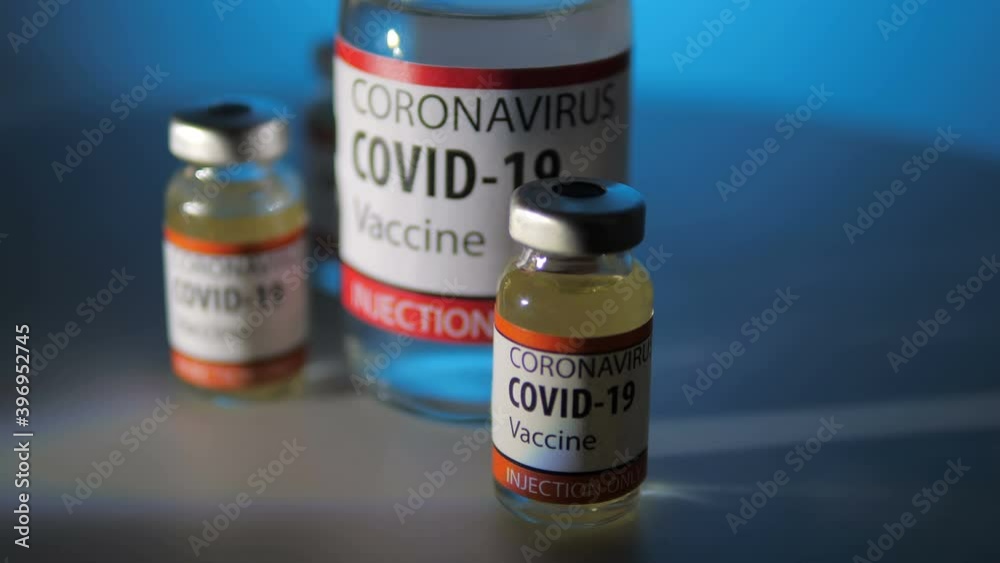 vials of hope - steady cam on bottle of anticovid vaccine with two small vials vials of hope - steady cam on bottle of anticovid vaccine with two small vials