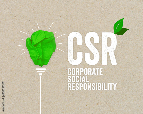 Green paper light bulb metaphor for recycling and acronym CSR - corporate social responsibility renewable energy green climate concept on brown recycled paper photo