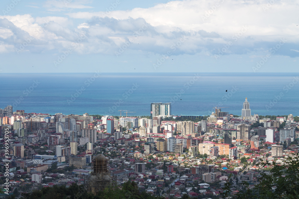 Evening landscape. Top view of the Black sea, the sea port of Batumi against the background of white clouds. Space for text, design cards, calendars, or posters. Georgia. Evening landscape. Top view of the Black sea, the sea port of Batumi against the background of white clouds. Space for text, design cards, calendars, or posters. Georgia.
