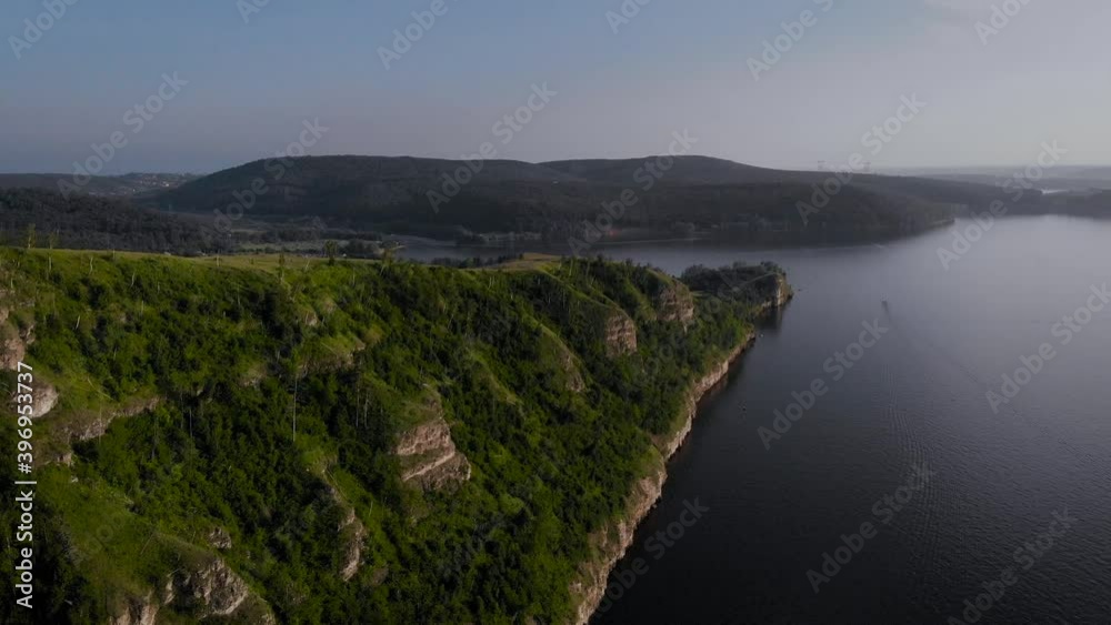 View from above. Beautiful shore of lake or sea, rock with green trees. View from above. Beautiful shore of lake or sea, rock with green trees.