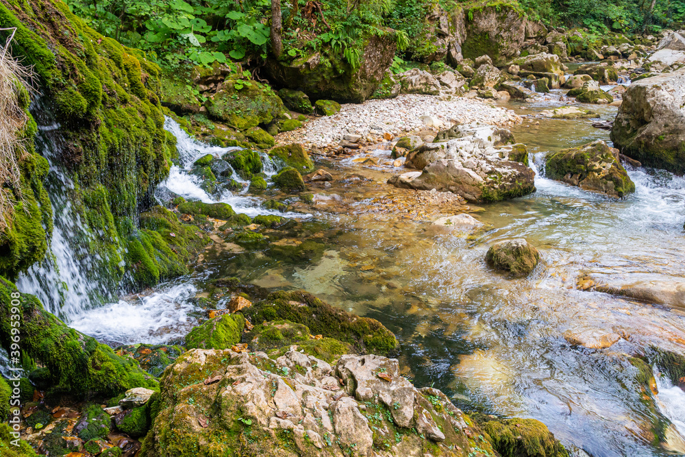 Ecology and nature. The source of clean drinking spring water among stone rocks and moist fresh green moss Ecology and nature. The source of clean drinking spring water among stone rocks and moist fresh green moss