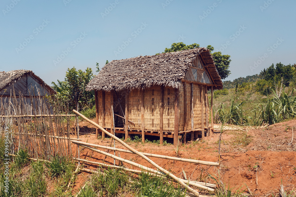 Traditional wooden african malagasy hut with roof from straw, typical village in central Madagascar.