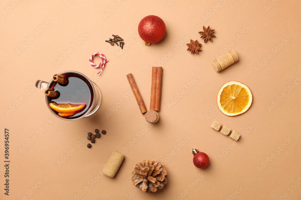 Cup of mulled wine and ingredients on brown background Cup of mulled wine and ingredients on brown background