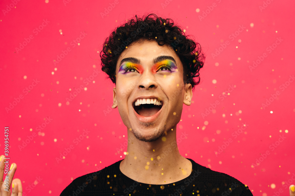 Excited gay man throwing glitter Stock Photo Adobe Stock