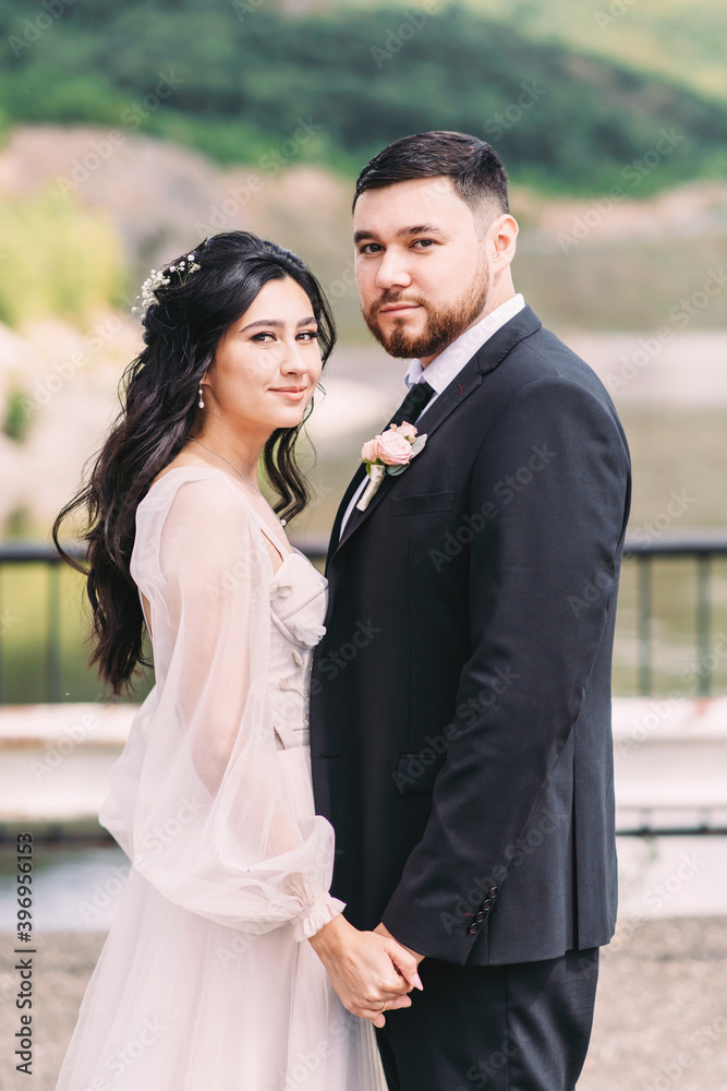 Walk the newlyweds in nature against the backdrop of wooded mountains Walk the newlyweds in nature against the backdrop of wooded mountains
