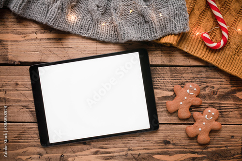 Christmas mockup with tablet, gingerbread men, festive and christmas cane, top view