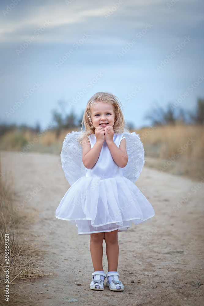 So sweet beautiful blonde angel with blue eyes in a white ball gown ...