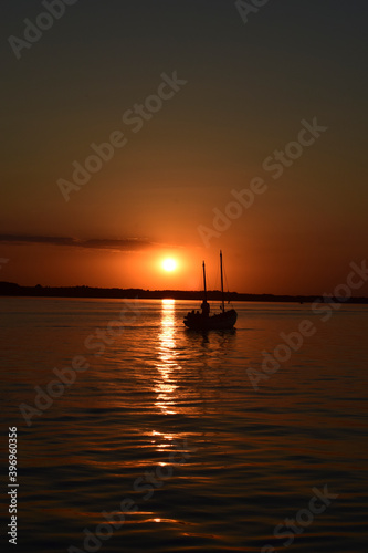 beautiful and sunny sunset on the lake © photoidea