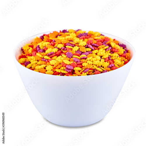 Colorful candies in white bowl isolated on white background, copy space. Cake decor