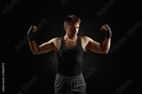 strong athletic bearded man on dark backgrround