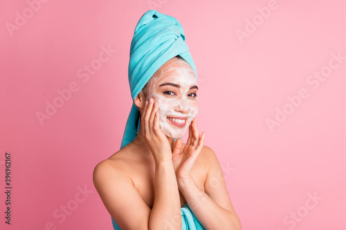 Photo of young asian woman enjoy cosmetology procedure apply cleansing foam isolated over pink color background