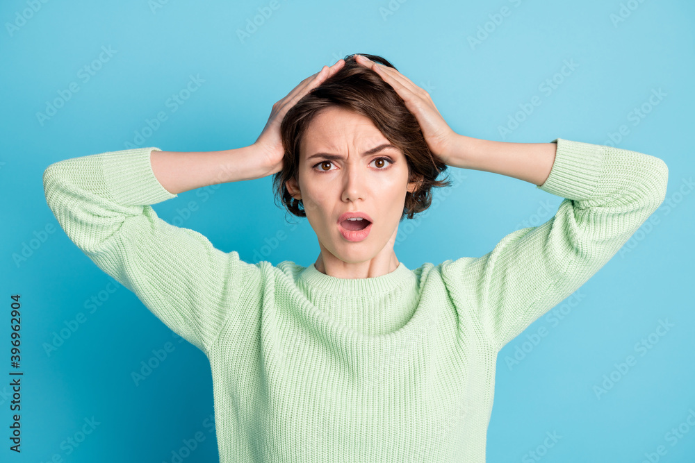 Portrait of stressed impressed short hairdo girl open mouth arms hair wear lime sweater isolated on teal color background Portrait of stressed impressed short hairdo girl open mouth arms hair wear lime sweater isolated on teal color background