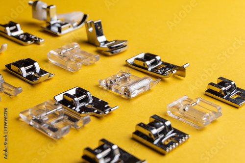 Presser foot for sewing machines. Universal feet for sewing clothes at home from different materials on a household typewriter. Feet for sewing different materials.  Individual tailoring
