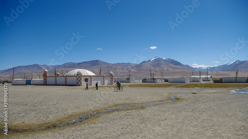 White and red sunni mosque on mountain background in high-altitude Alichur kyrgyz village on the Pamir Highway, Murghab district, in the Gorno-Badakshan region of Tajikistan