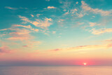 Sea view at sunset. Summer travel background. Vintage filter. Beautiful blue sky with clouds and sun on the horizon of the sea.