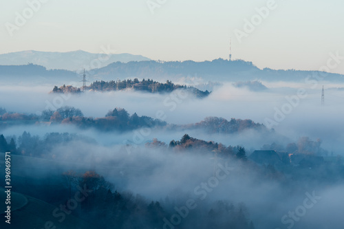 misty morning in Emmental with Bantiger and forest above the mist © schame87