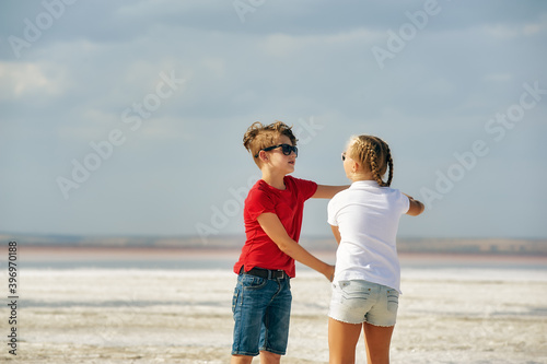 Cheerful children in nature. A boy and a girl are having fun on vacation.