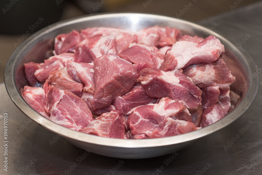 A bowl filled with fresh pork meat. A bowl filled with fresh pork meat.