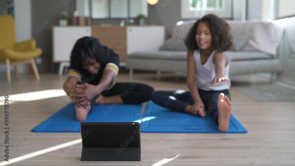 Mother and daughter doing fitness exercices at home Mother and daughter doing fitness exercices at home