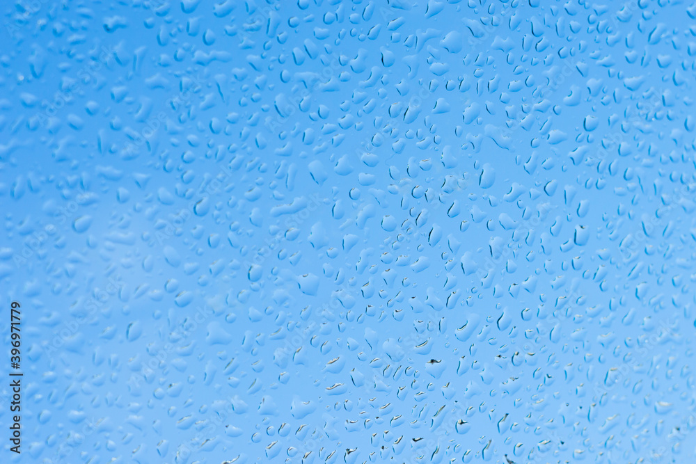 Water drops on glass and blue background. Water drops on glass and blue background.