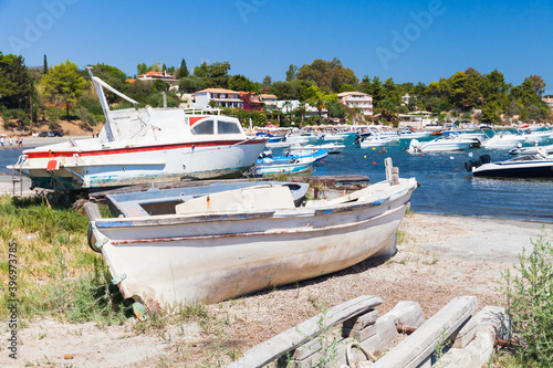 Old wooden fishing boats are on the coast in port photo