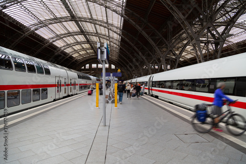 Two colored trains on railway station in germany
