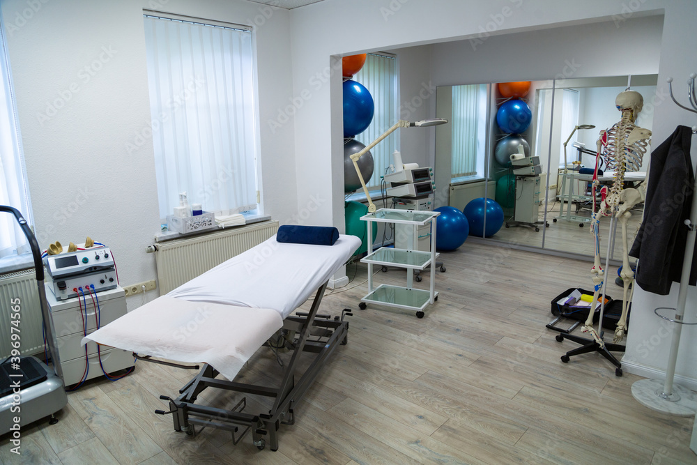 Medical cabinet for physiotherapywith massage couch and skeleton