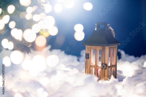 Magical Lantern On Snow With Christmas Decoration and holiday lights. © erika8213