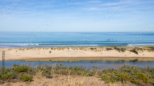 two stand up paddle boarders on the onkaparinga river located in port noarlunga south australia on November 27th 2020