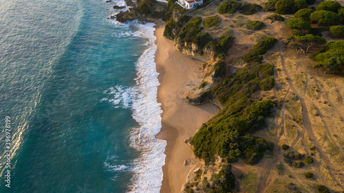 Cliffs with beautiful sand beaches on the Atlantic coast in Andalusia seen from above. Aerial drone view of beautiful Spanish andalusian beach