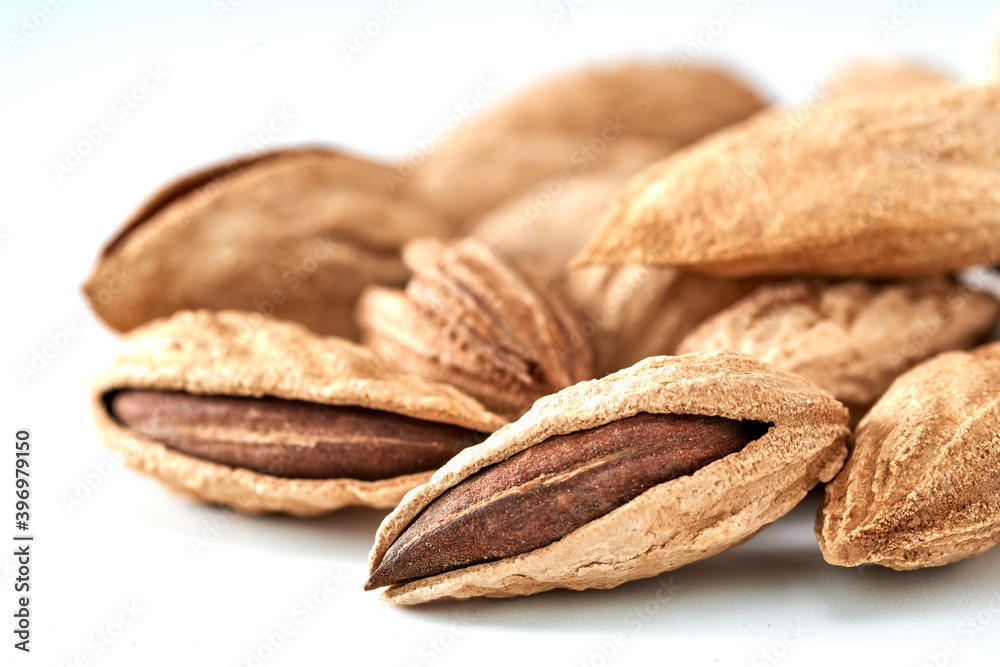 Almonds are the kernel of the nut was lying on a white background.Space for text Almonds are the kernel of the nut was lying on a white background.Space for text