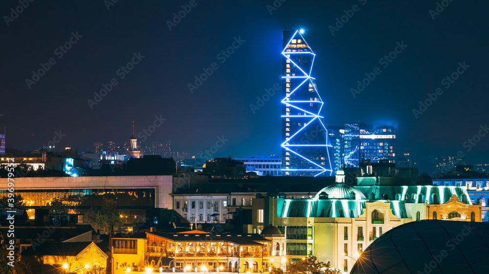 Fototapeta premium Tbilisi, Georgia. Modern Urban Night Cityscape. Evening Night Scenic Top View Of City Center