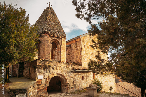 Mtskheta, Georgia. Church Of St John The Baptist In Shio-Mgvime Monastery. Medieval Monastic ShioMgvime Complex In Limestone Canyon photo
