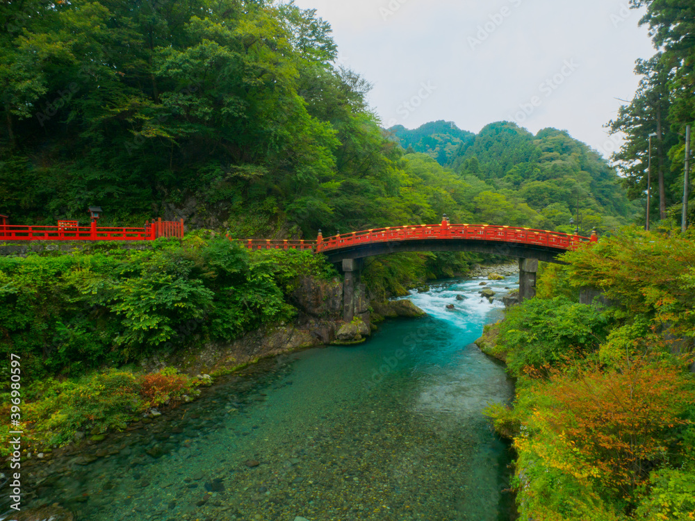 Naklejka premium Traditional Japanese bridge over a clear stream (Tochigi, Japan)