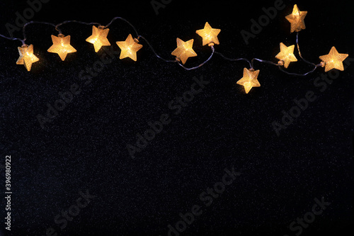 Christmas decoration with bright stars over black background