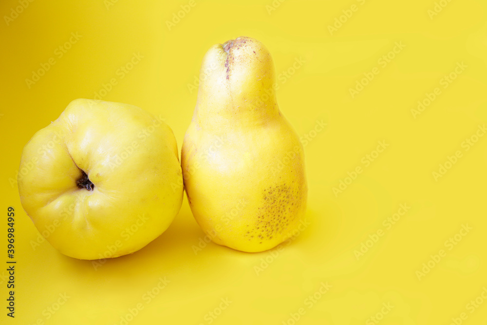Fresh quince fruits against yellow background