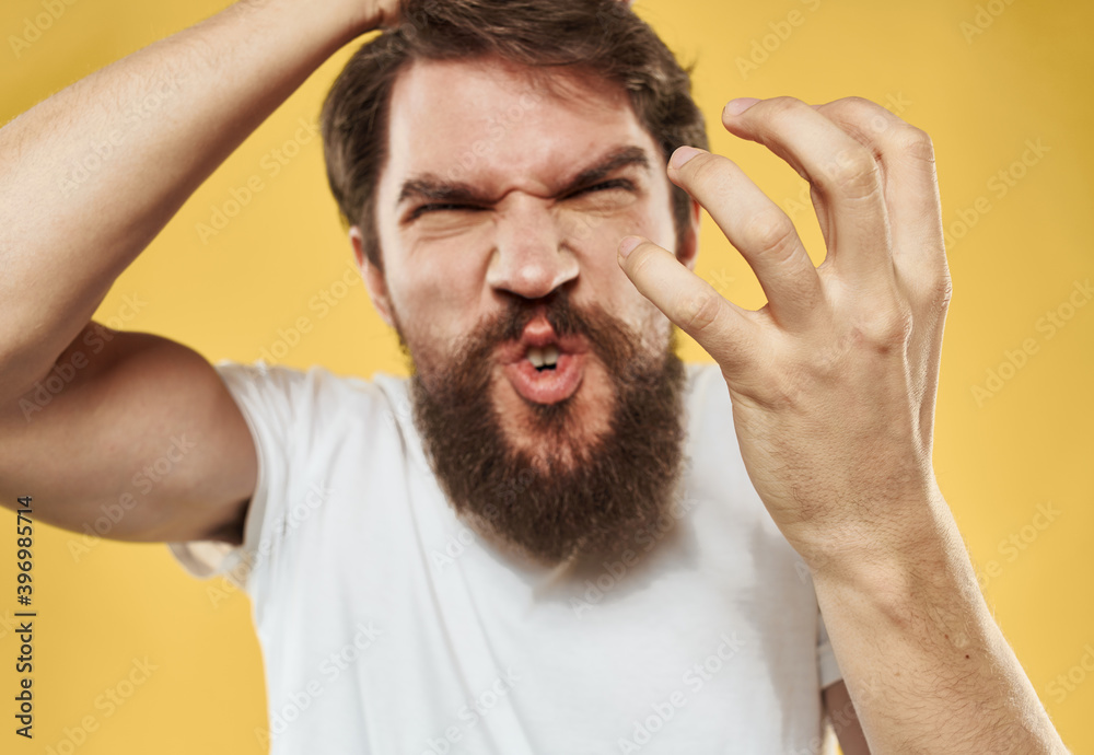 Obraz premium Angry man in white T-shirt mental deviation thick beard model