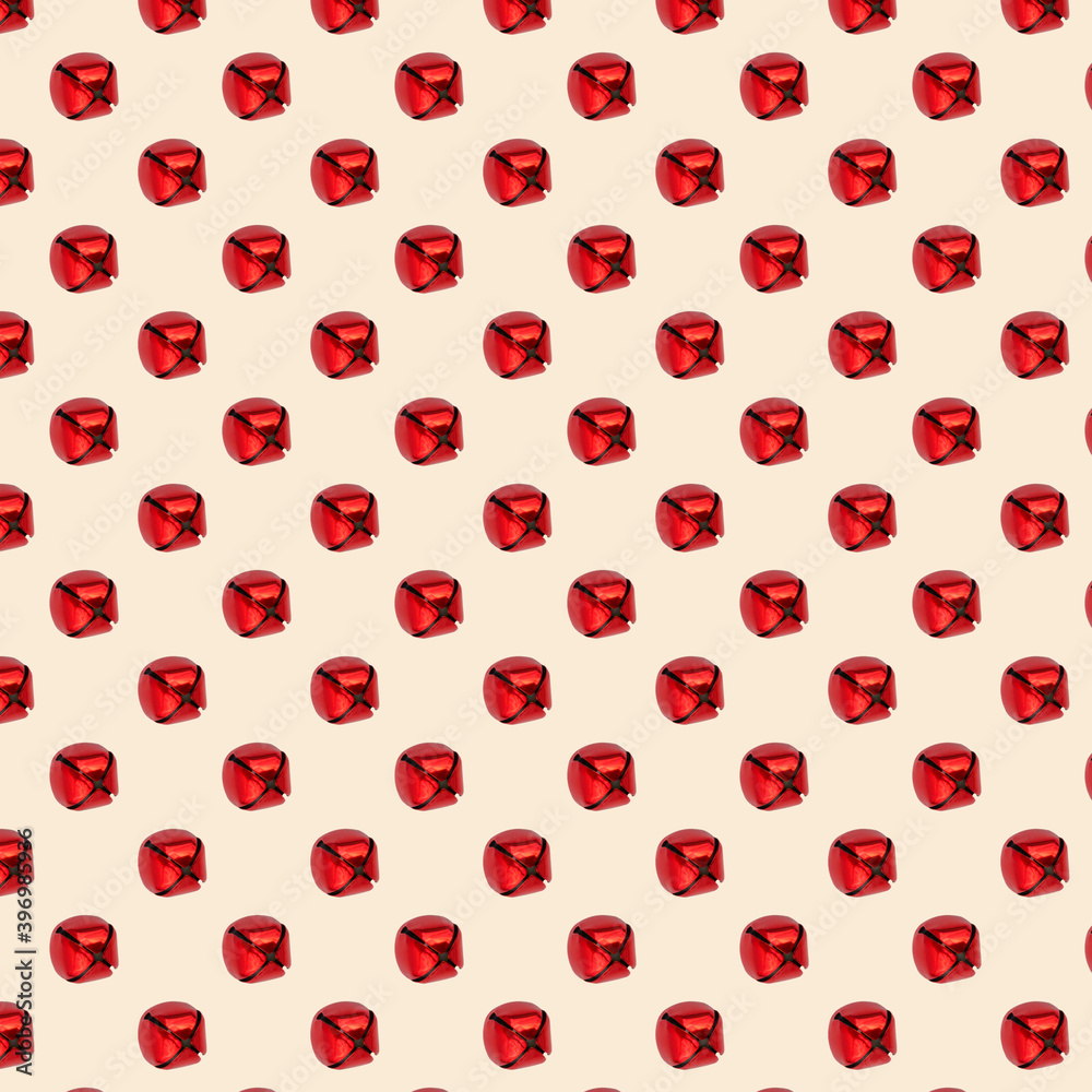 Isolated red jingle bell on a beige background. Seamless pattern. Christmas. New Year Isolated red jingle bell on a beige background. Seamless pattern. Christmas. New Year