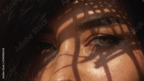 Sexy languid look of asian woman with sexy makeup and in straw hat. Closeup beautiful hazal woman's eyes with elegant shadow on face. Beauty, race minority, portrait, commercial concept and lifestyle.
