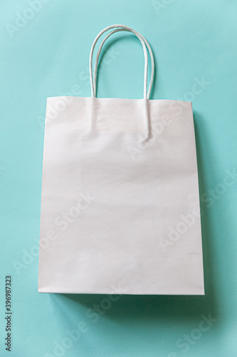 Simply minimal design shopping bag isolated on blue pastel background. Online or mall shopping shopaholic concept. Black friday Christmas season sale. Flat lay top view copy space, mock up