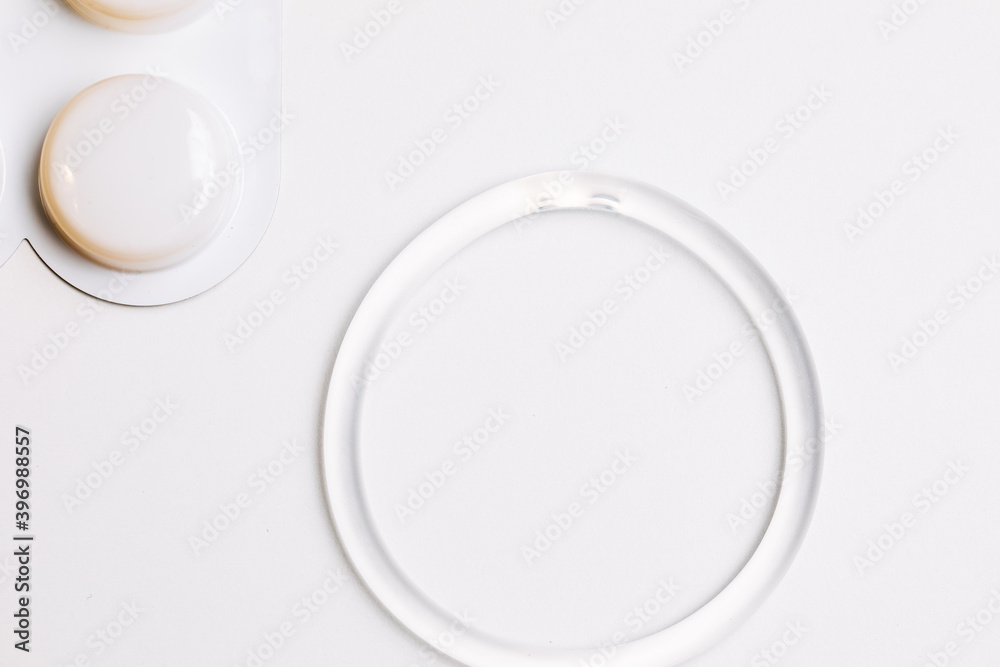 hormone ring and tablets on a white background. Contraceptive ring hormone ring and tablets on a white background. Contraceptive ring