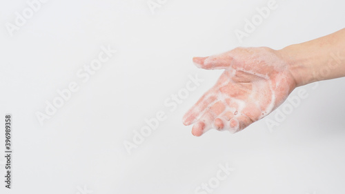 Washing hands with soap foam wipe for prevention and hygiene on white background.