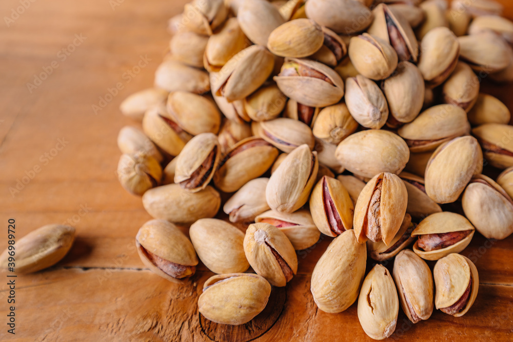 Green fresh pistachios as texture on wooden background Green fresh pistachios as texture on wooden background