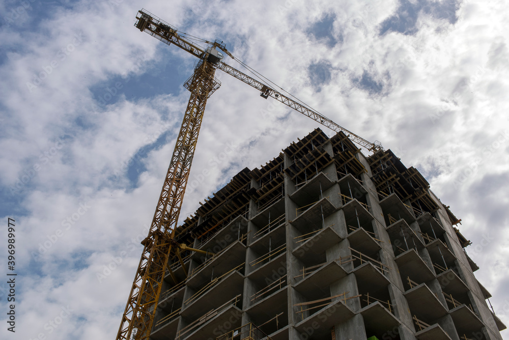 Naklejka premium Tower crane. Construction site. Production of apartments, social housing.