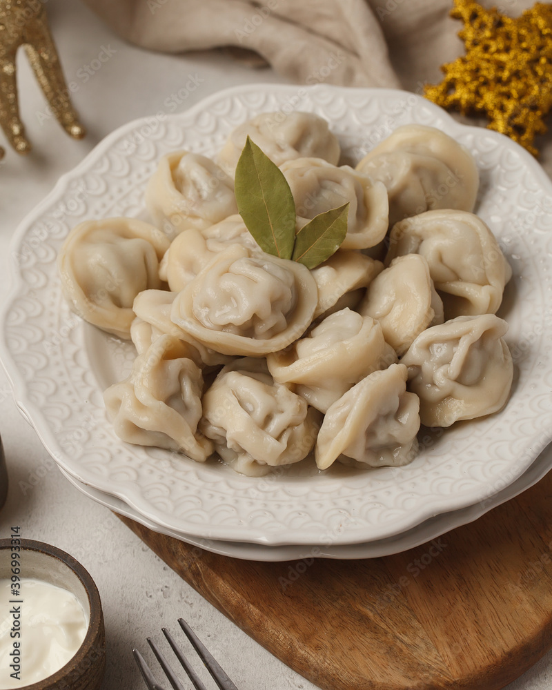 Prepared semi-finished products. Dumplings, khinkali, manti. New year's atmosphere Prepared semi-finished products. Dumplings, khinkali, manti. New year's atmosphere