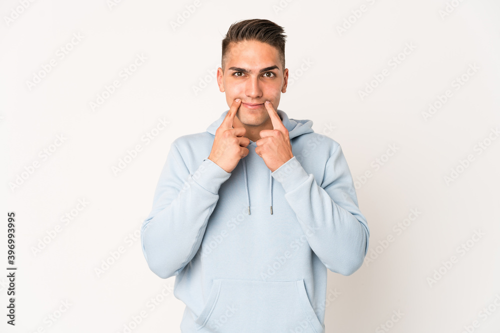 Young caucasian handsome man isolated doubting between two options. Young caucasian handsome man isolated doubting between two options.